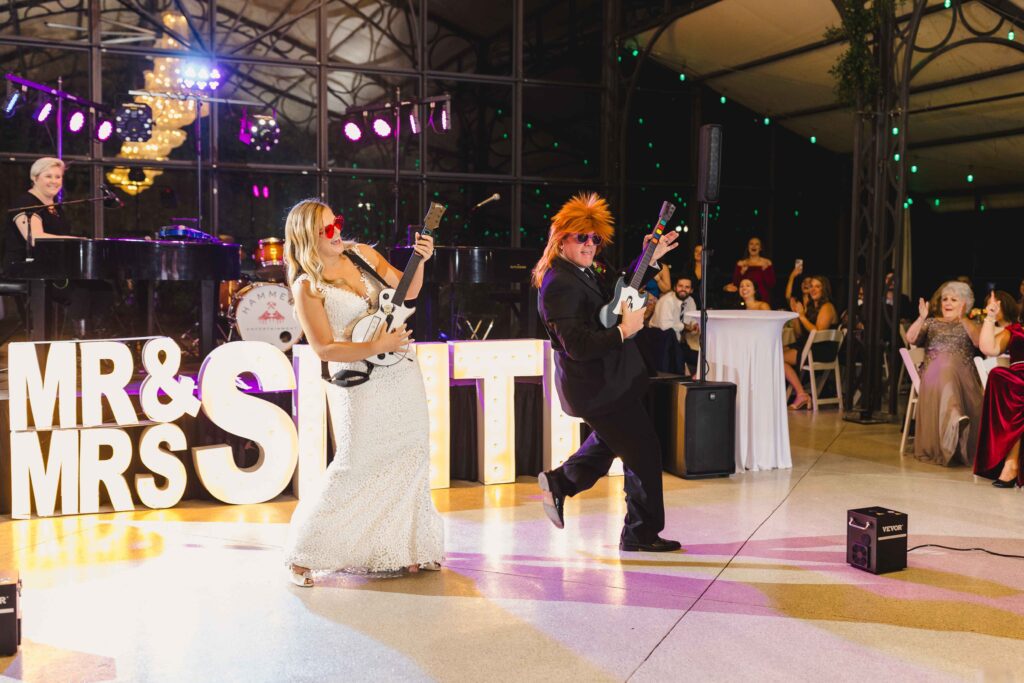 Bride and her father playing the guitar during their wedding reception.