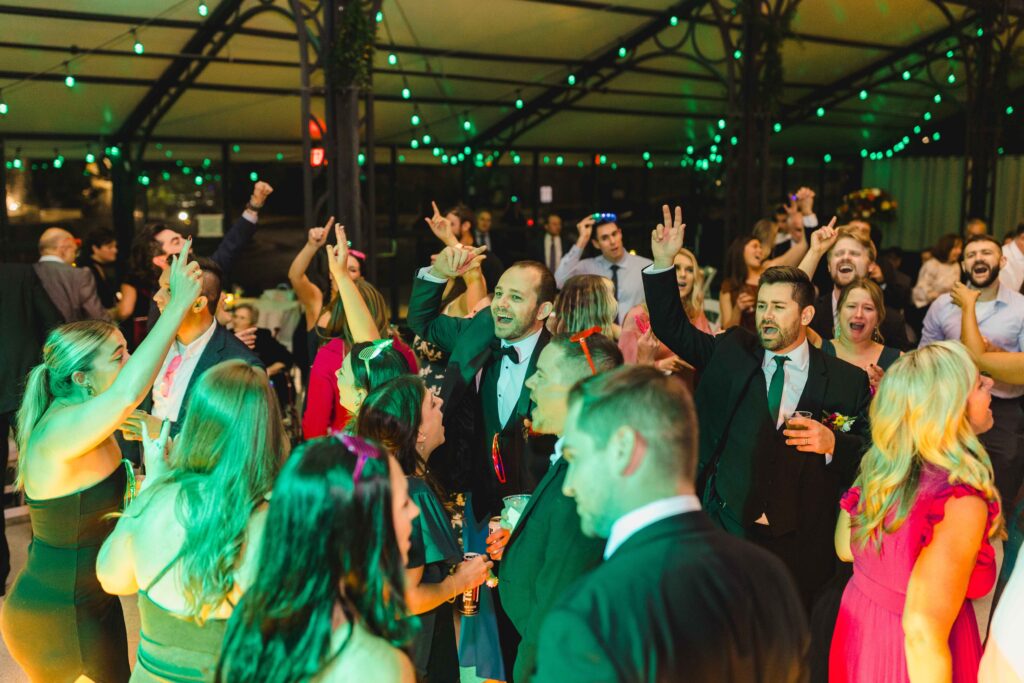 Wedding guests dancing on the dance floor at Avent Orangery. 