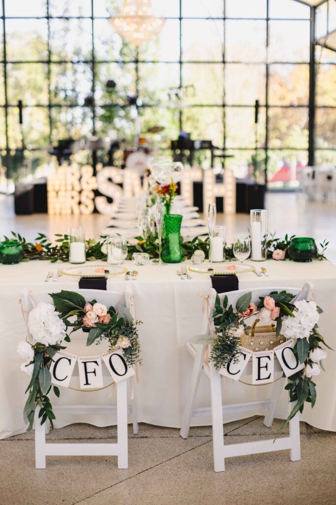 Wedding detail shot of the bride and groom chairs at their wedding reception. 