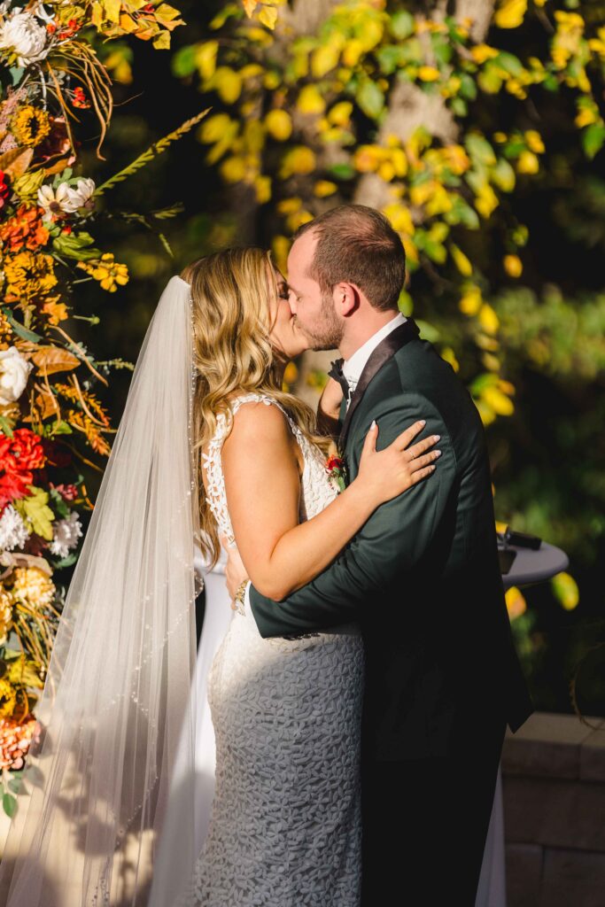 Bride and groom kissing at the altar during their luxury wedding in Kansas City.