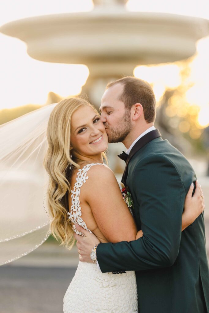 Close up of bride and groom posing for their couple portraits taken by their Kansas City wedding photographer. 