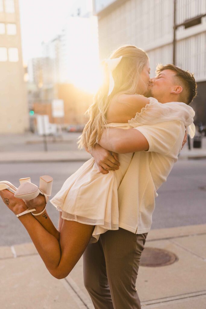 Couple kissing at sunset in downtown Kansas City.