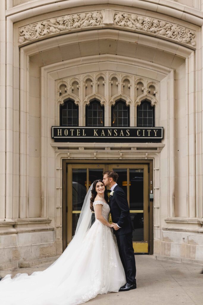 Couple posing outside of Hotel Kansas City.