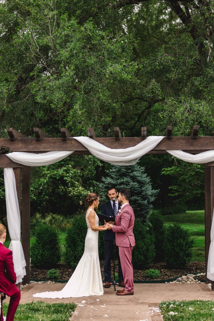 Couple holding hands at the altar taken by a Kansas City Photographer.