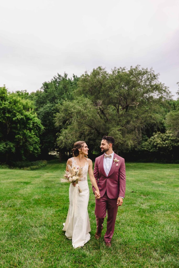 Wedding portraits of couple walking and smiling.