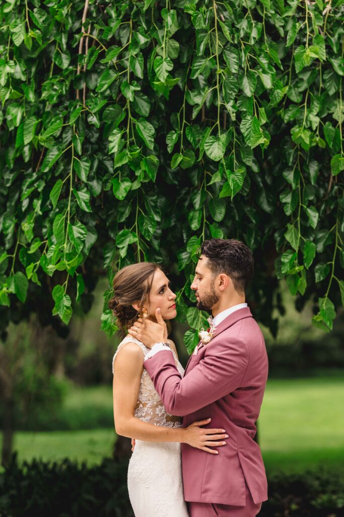 Couple portrait under a large tree at their wedding venue.