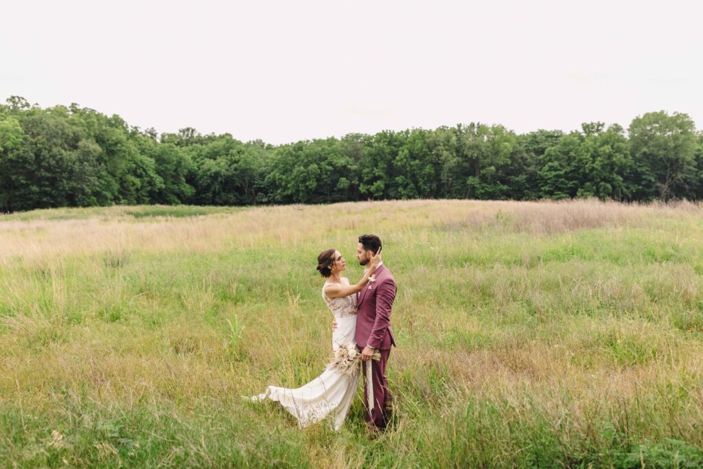 Newlyweds looking into each others eyes in an open field at the Legacy at Green Hills.