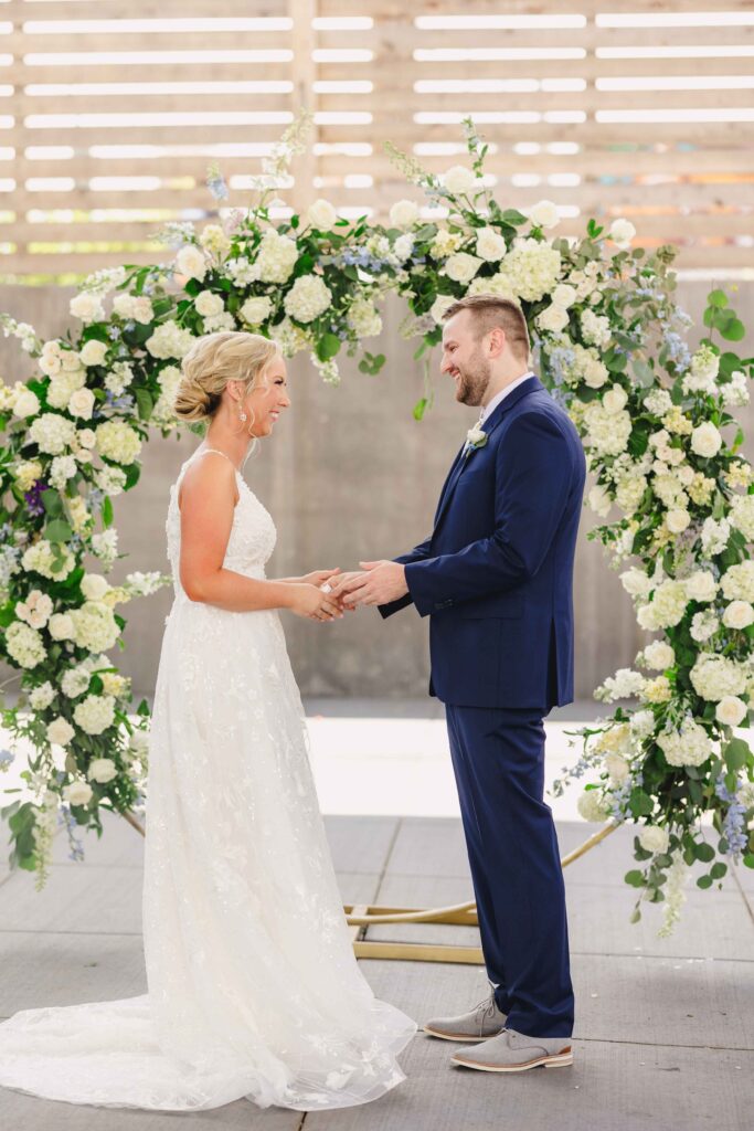 Bride and groom smiling at each other during a first look captured by a Kansas City Photographer.