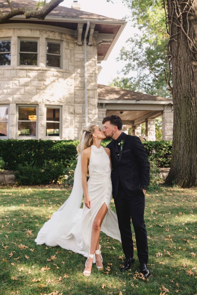 Newlywed couple kissing and walking captured by their Kansas City Photographer.