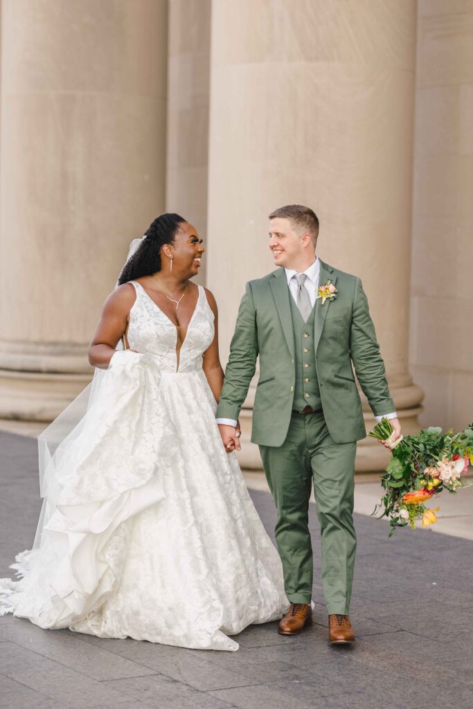 Bride and groom walking outside of their Nelson Atkins wedding.