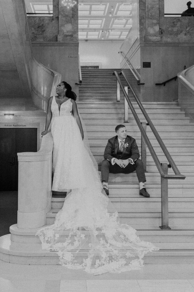 Bride and groom looking off into the distance inside the Nelson Atkins Museum of Art. 