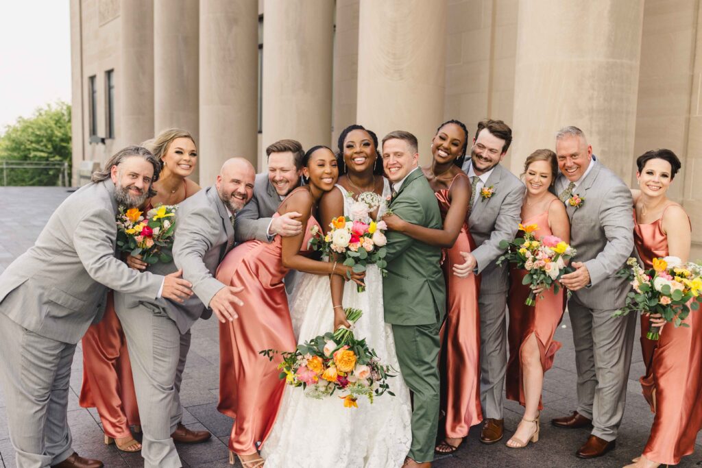 Bridal party having a group hug. 