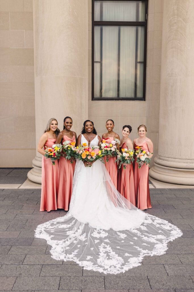 Bride and her bridesmaids posing for formal photos. 