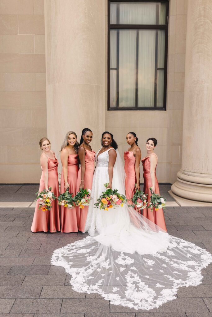 Bride and bridesmaids posing outside the Nelson Atkins wedding.