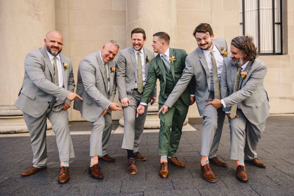 Groom and groomsmen showing off their fun socks. 