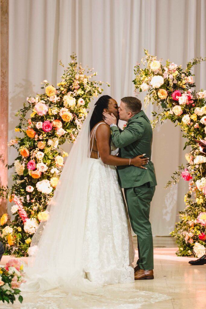 Bride and groom kissing after saying "I do" at their Nelson Atkins wedding.