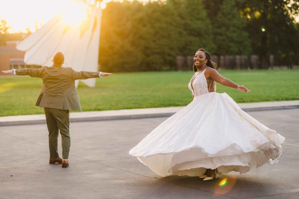 Bride and groom posing playfully during their golden hour wedding portraits at their Nelson Atkins wedding.