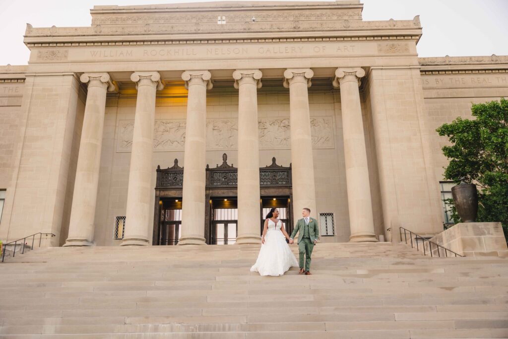 Newlyweds walking down the steps of their Nelson Atkins wedding, their Kansas City MO Wedding Venue. 