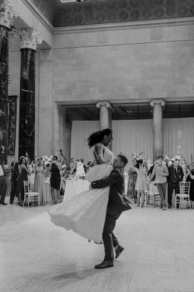 Groom spinning the bride around during their first dance. 