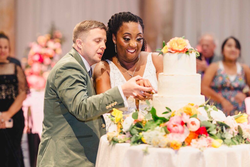 Bride and groom cutting cake at their Nelson Atkins wedding.