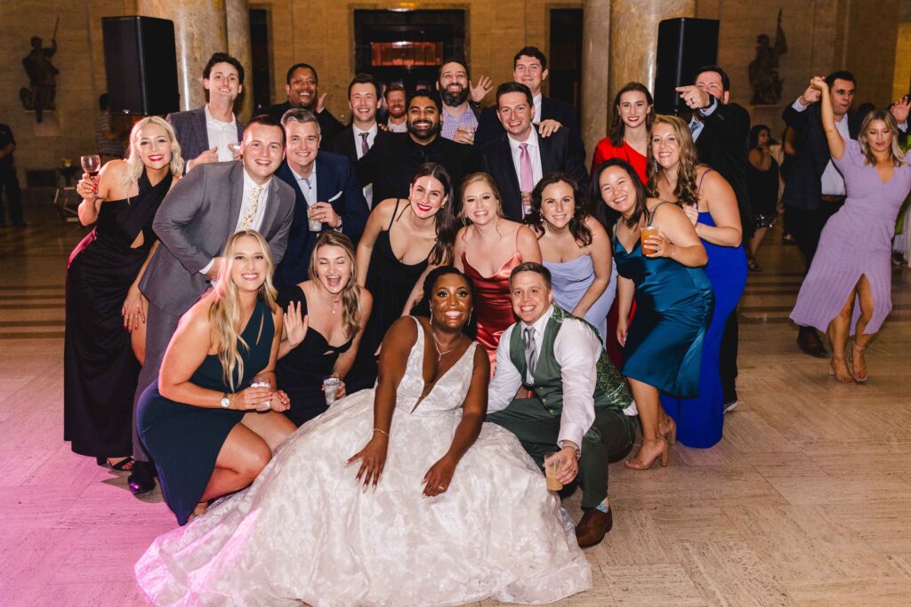 Group shot of the newlyweds and guests on the dance floor of the Nelson Atkins wedding.