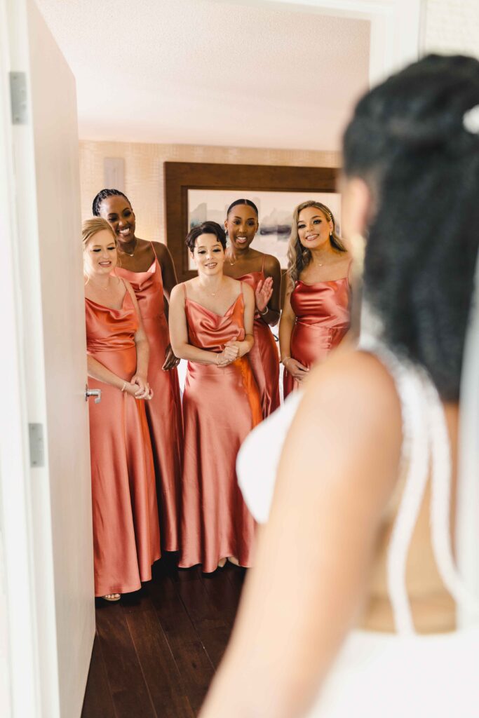 Bride having a first look with her bridesmaids. 