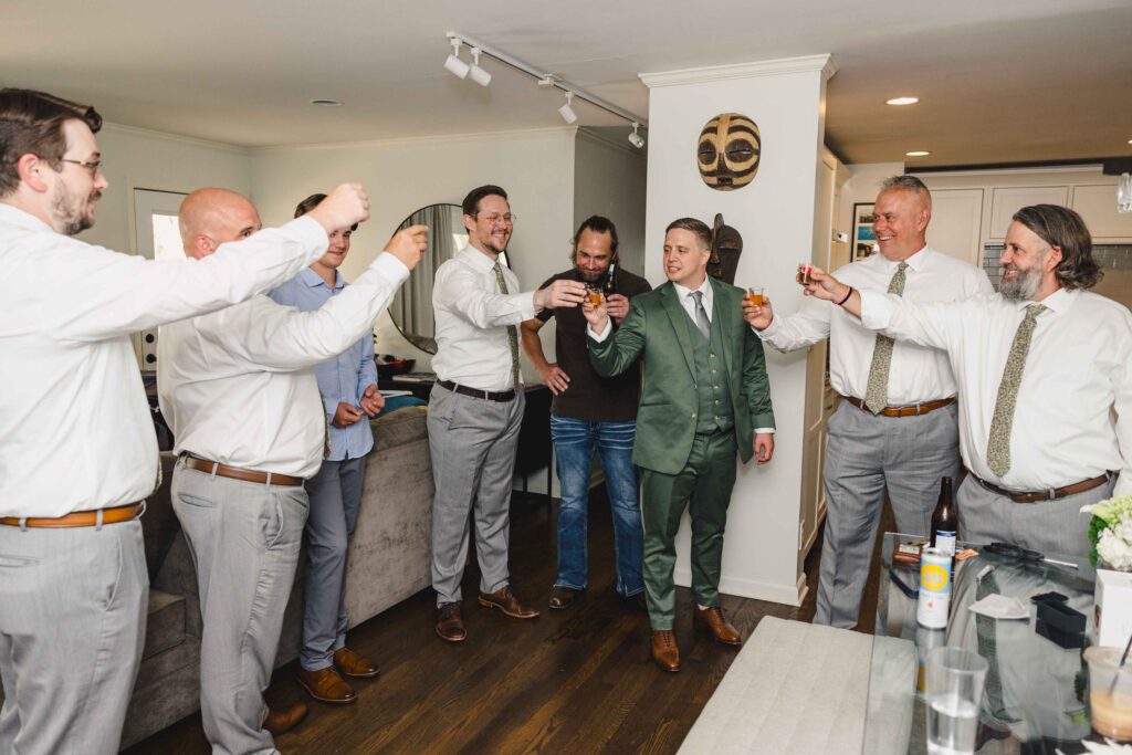 Groom and his groomsmen taking a shot before going to their Nelson Atkins wedding.