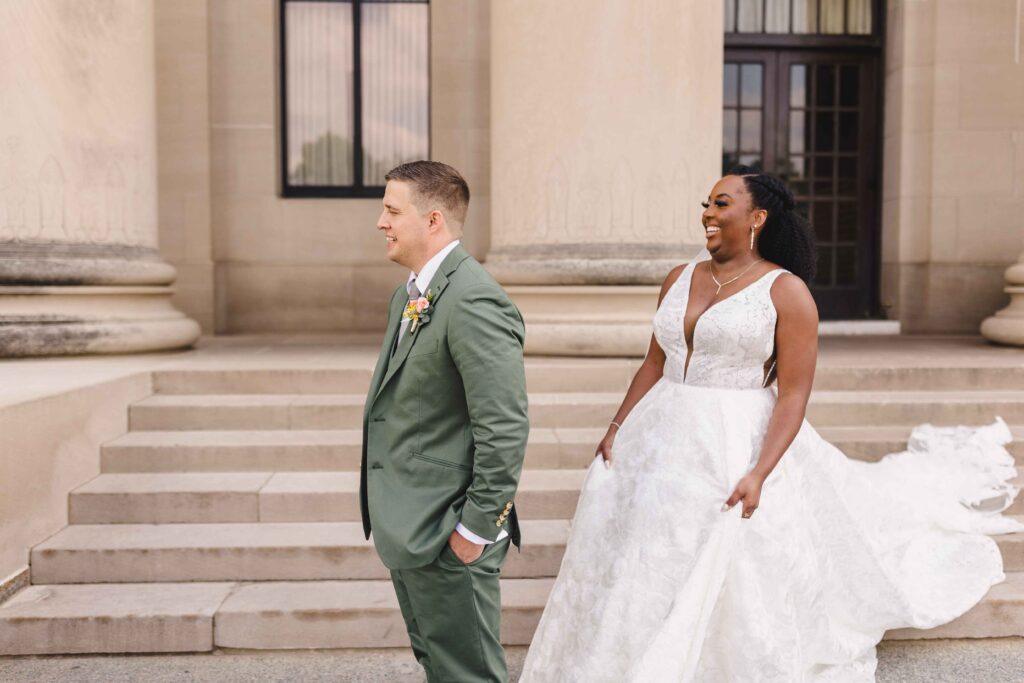 Bride standing behind the groom, about to have their first look. 