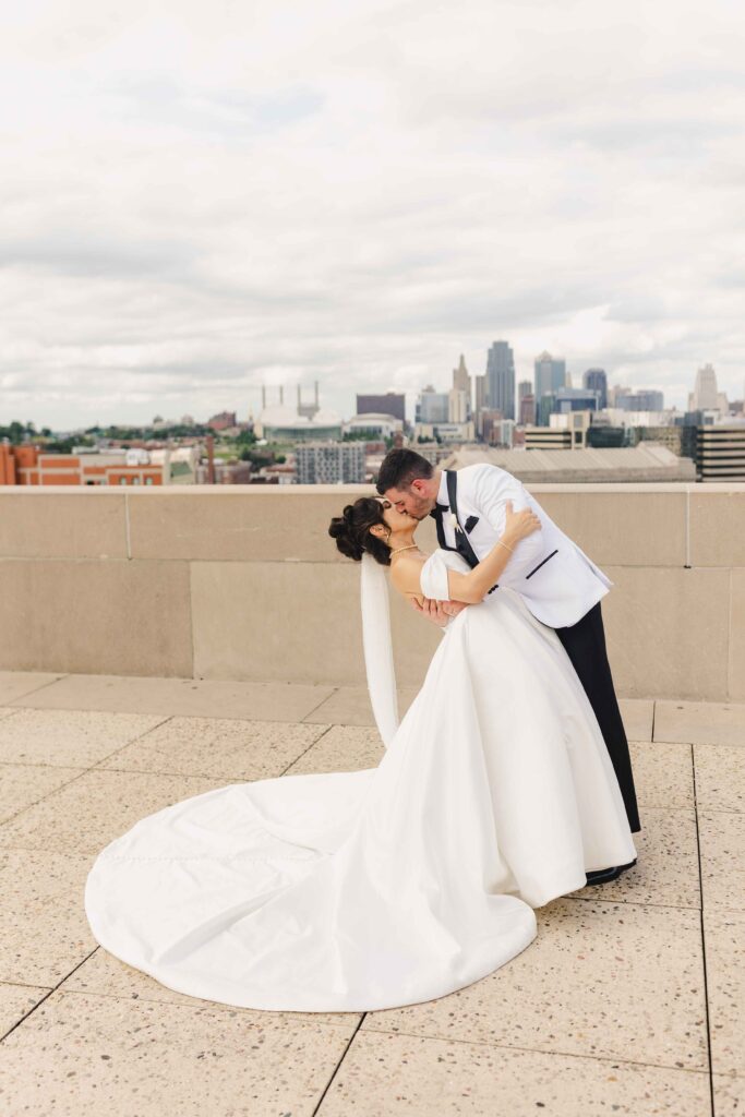 The groom dipping his bride for a kiss at Liberty Memorial in Kansas City.