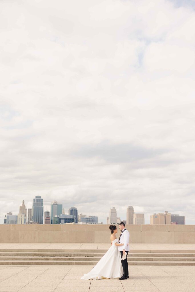 Bride and groom holding one another at Liberty Memorial in Kansas City.