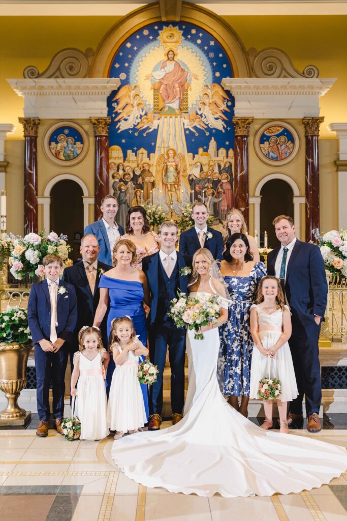 Bride and groom in a big family photo taken from their wedding family photos list.