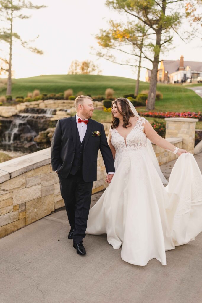 Bride and groom walking and talking together after their Oakwood Country Club wedding.