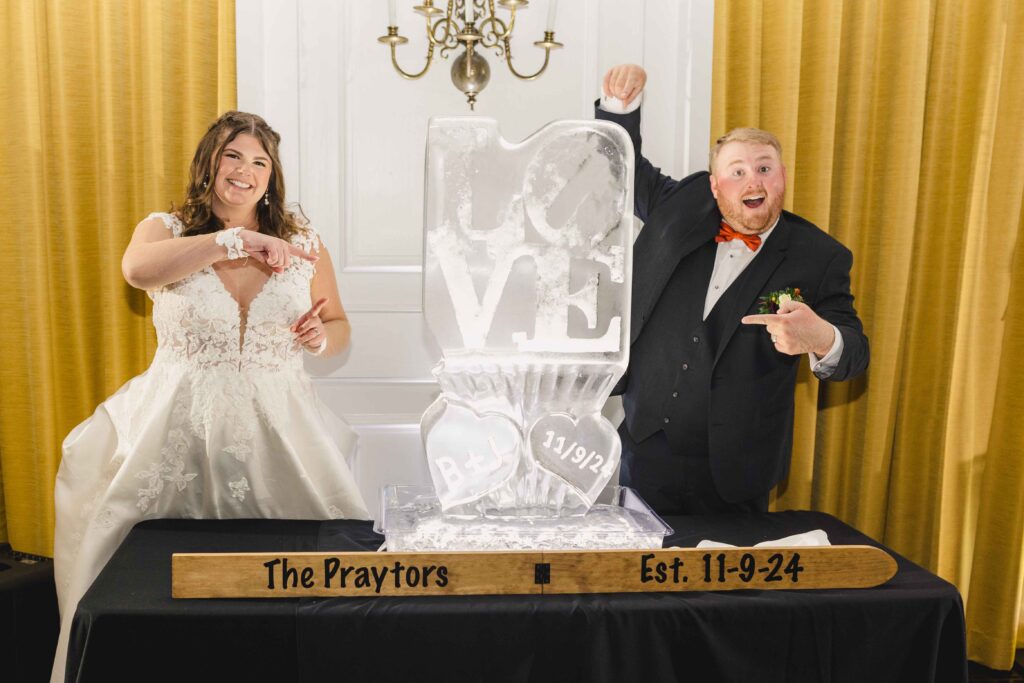 Bride and groom with their ice sculpture. 