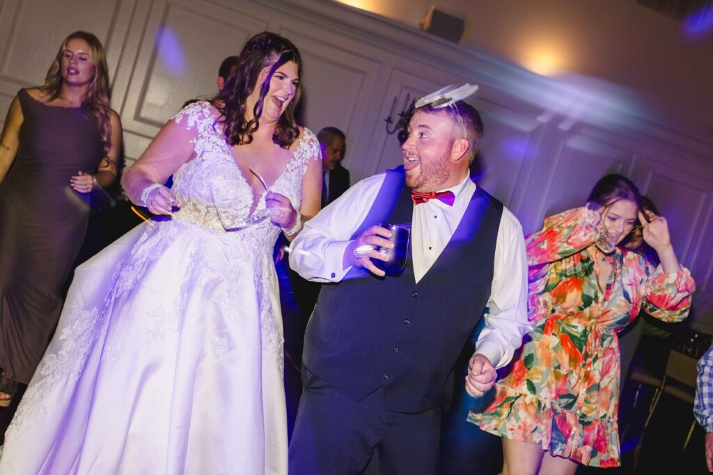 Bride and groom dancing and acting silly. 