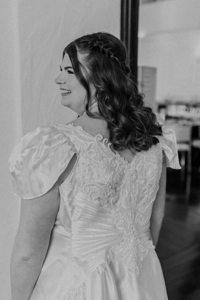 Bride smiling after getting her hair and makeup done. 