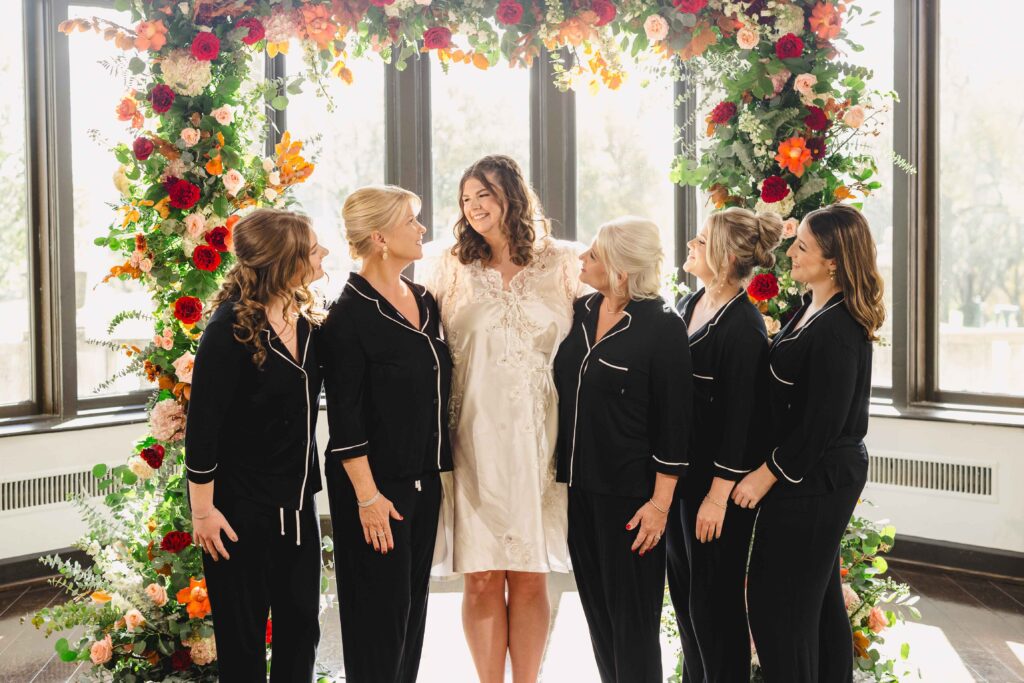 Bridal party smiling while getting ready before they get dressed. 