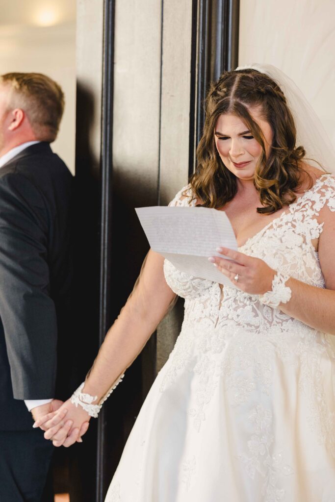 Bride crying as she reads her letter to the groom. 