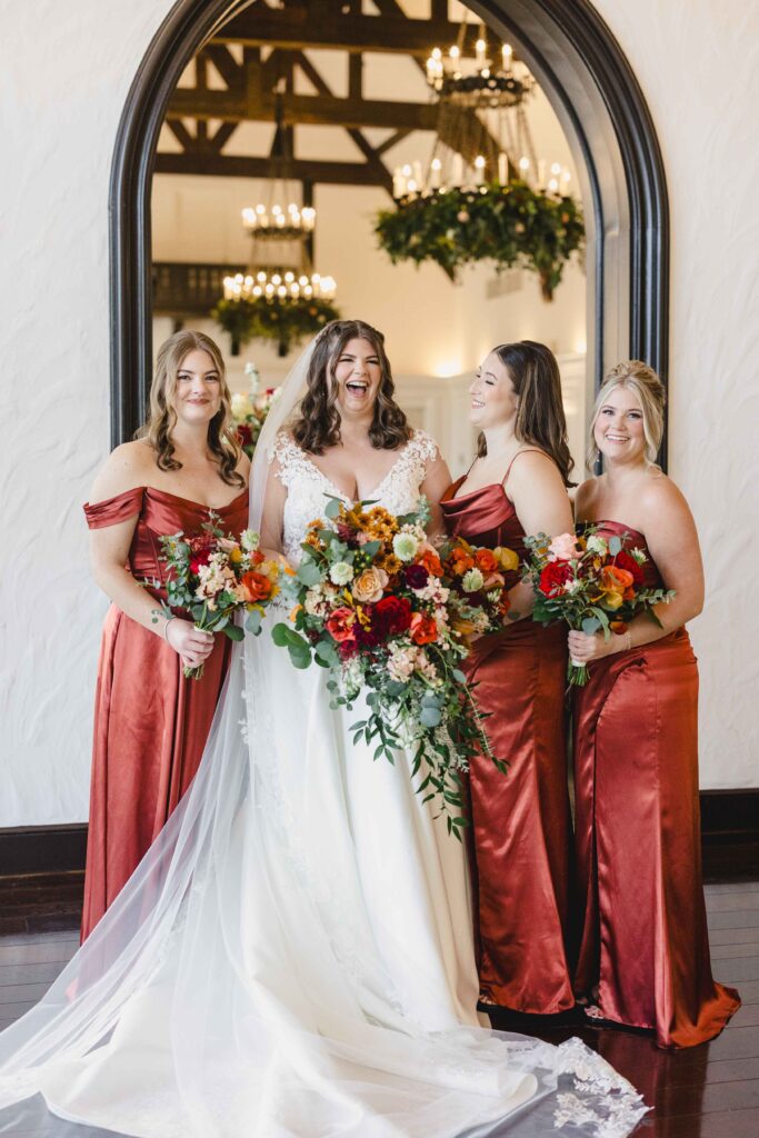 Bride and bridesmaids laughing together. 