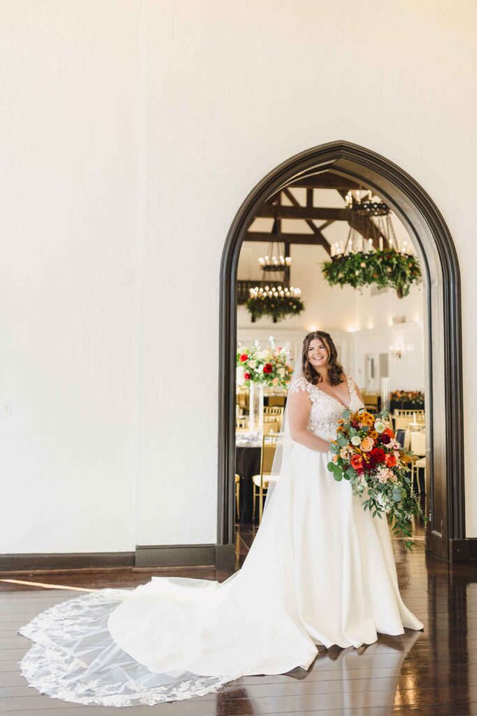 Bridal portrait of the bride in her wedding dress with a cathedral veil at her Oakwood Country Club wedding.