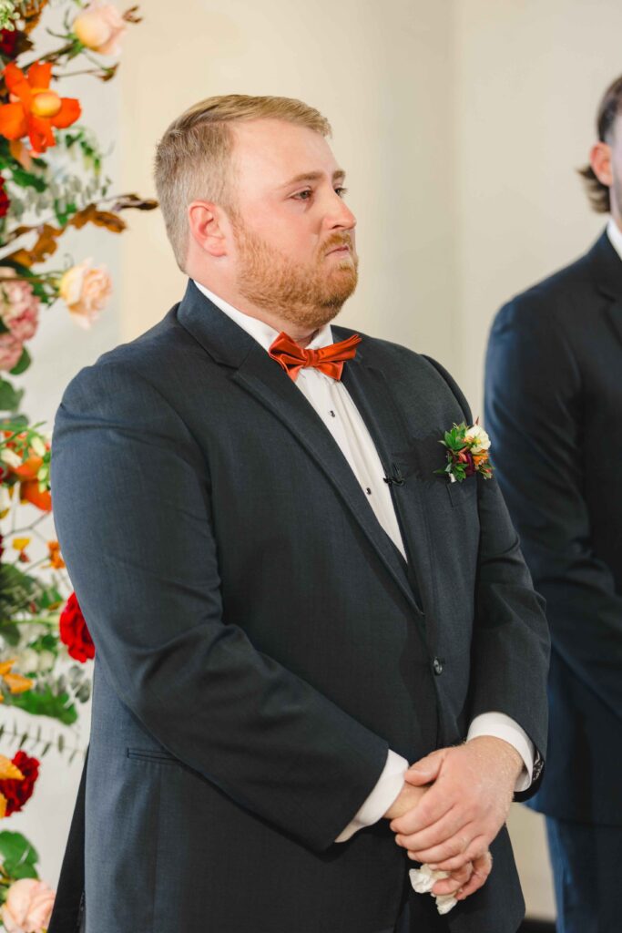 Groom crying as he sees his bride walk down the aisle. 