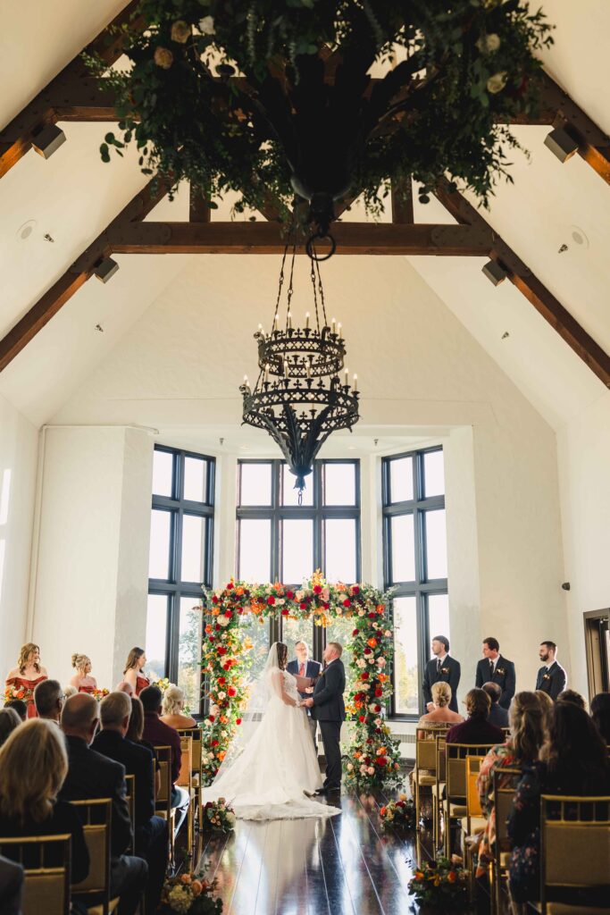 An Oakwood Country Club wedding ceremony with guests watching the bride and groom.