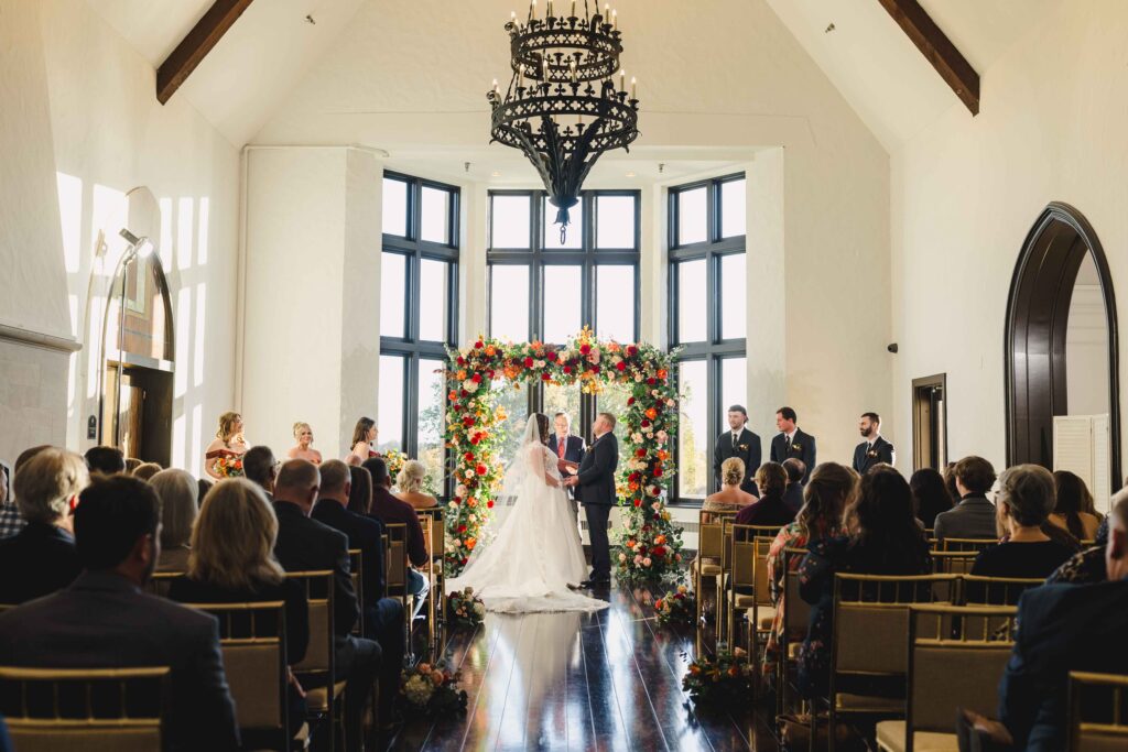 Bride and groom holding hands at the altar of their Oakwood Country Club wedding.