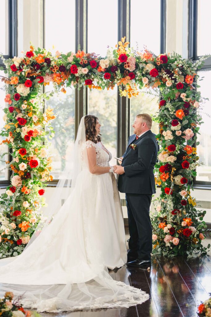 Bride and groom holding hands at the altar of their Oakwood Country Club wedding.