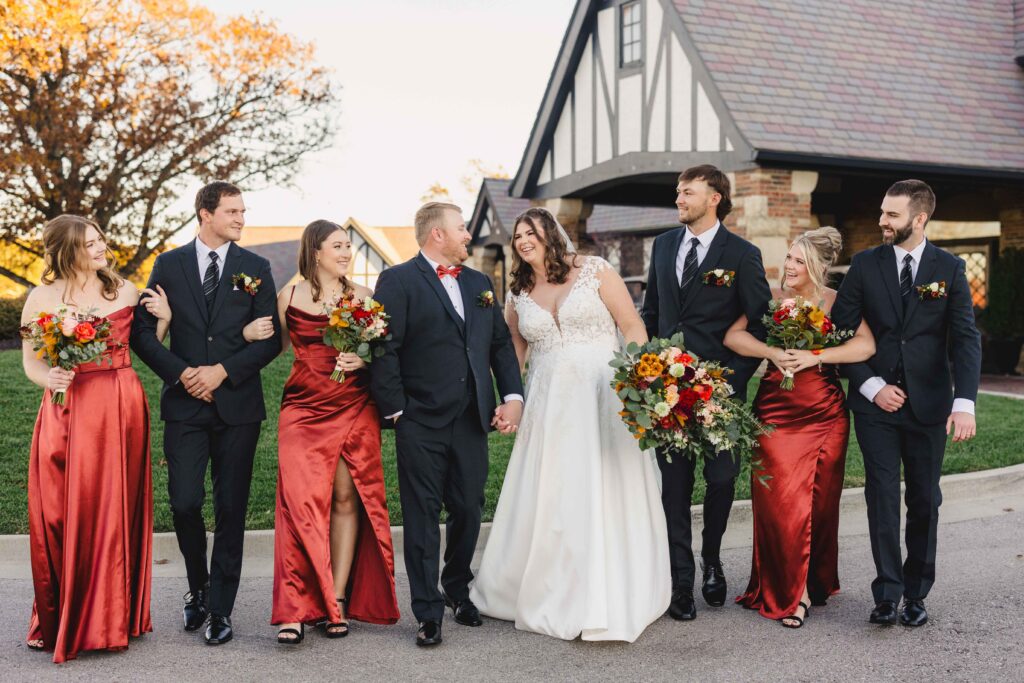 Wedding party walking together outside the Oakwood Country Club.