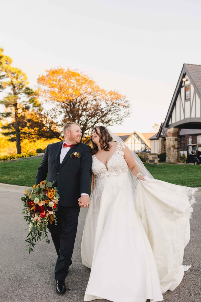 Newlyweds walking outside the Oakwood Country Club.