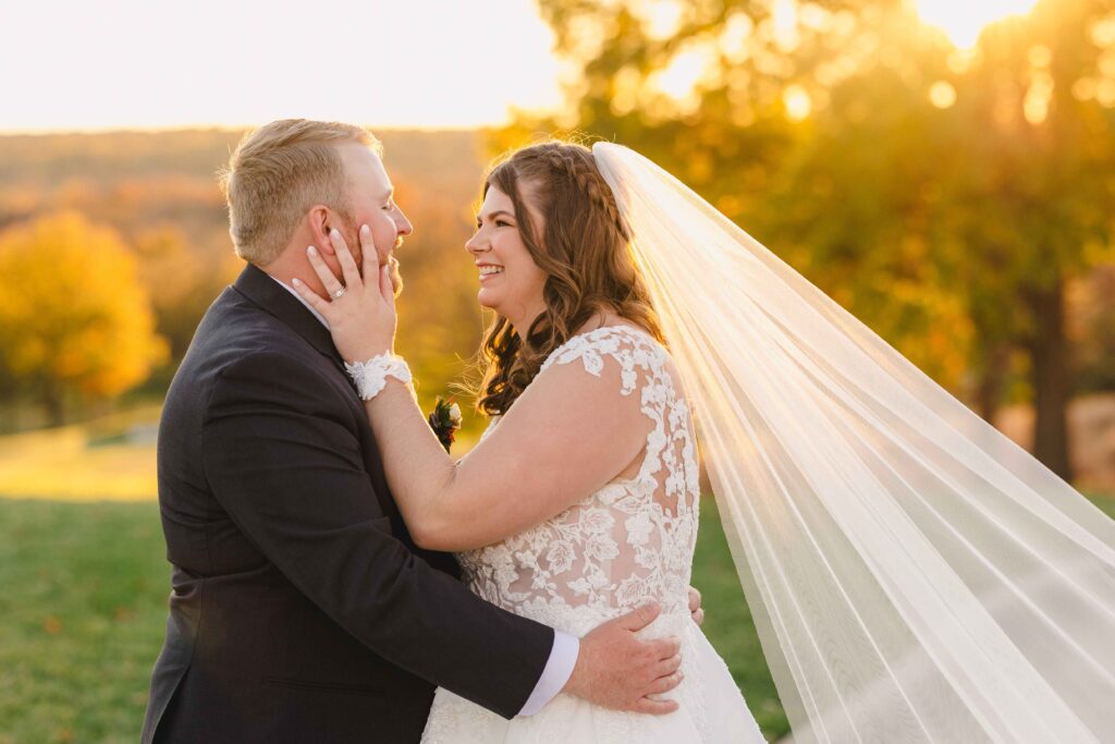 Bride and groom holding one another during golden hour portraits. 