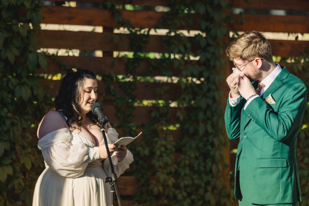 Bride giving her vows as the groom cries. 