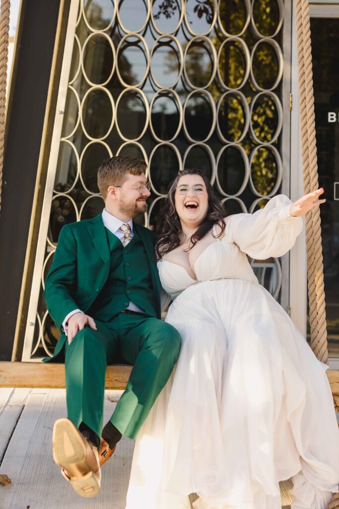 Bride and groom swinging on a swing at The Magnolia Brookside. 