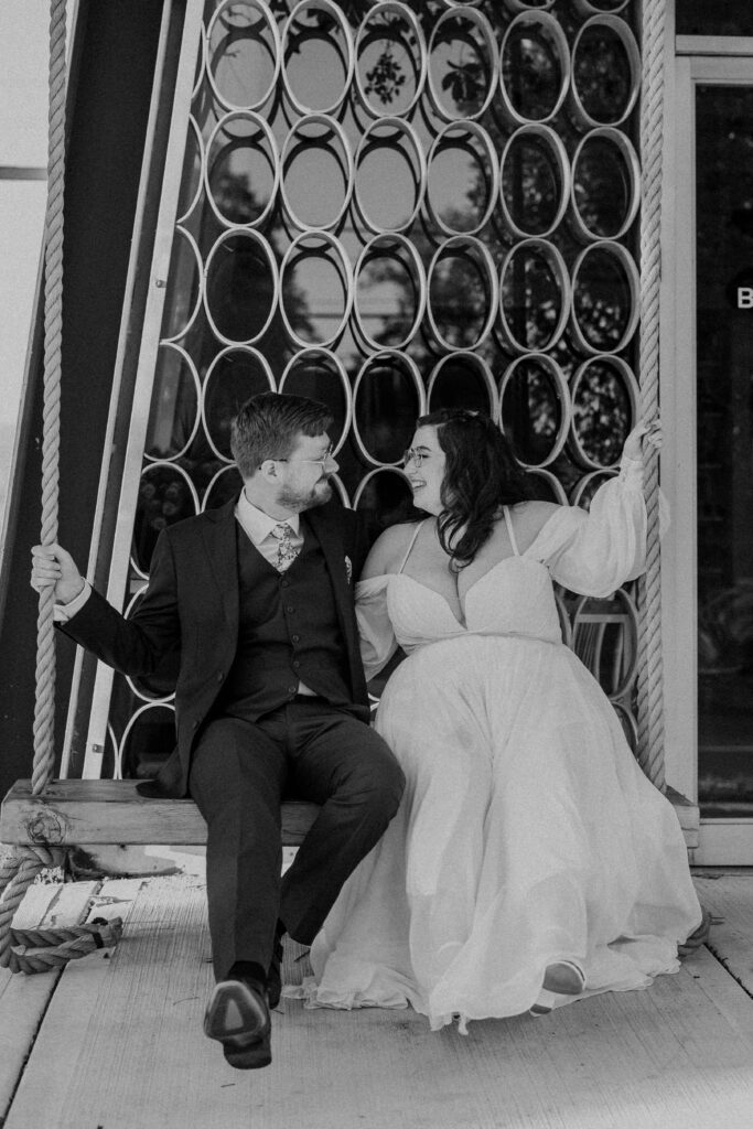 The newlyweds swinging after their Kansas City wedding ceremony. 