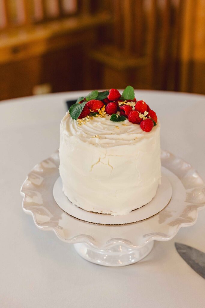 Wedding cake topped with berries. 